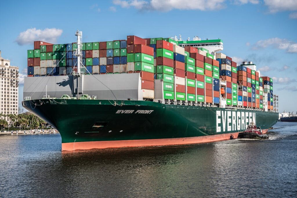 Green cargo ship on water representing shipping services near Utah by Mane Shipping for reliable delivery solutions.