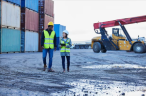 Two professionals walking together discussing logistics, representing Mane Shipping and professional shipping services in Utah