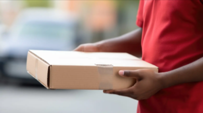 Reliable mail and shipping services in Utah by a Your Brand Name employee holding a sealed package ready for secure delivery